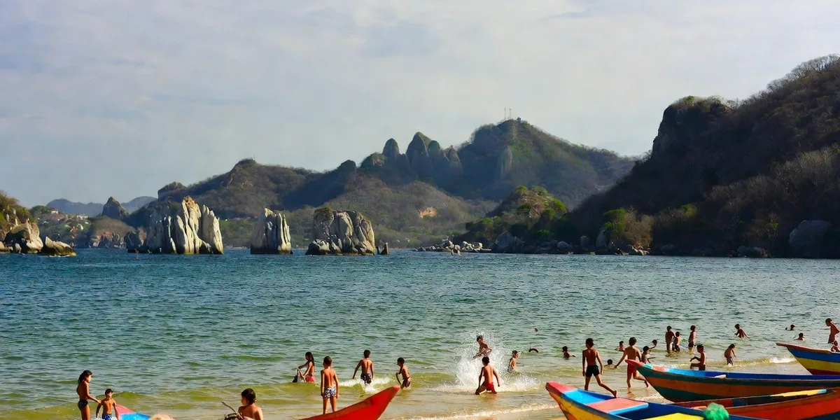 Mismaloya cove south of Puerto Vallarta with pangas on the sand and the Los Arcos rock islands offshore