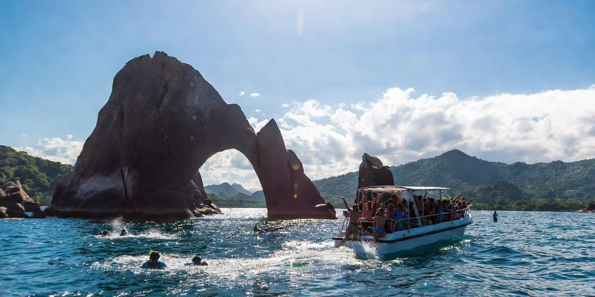 Snorkel tour boat approaching the Los Arcos rock formations in Banderas Bay near Puerto Vallarta