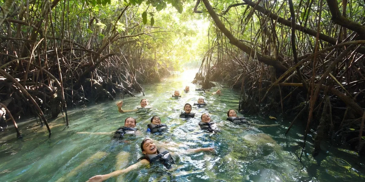 Visitors floating down the narrow mangrove-lined freshwater channel at Muyil in the Sian Ka'an biosphere reserve