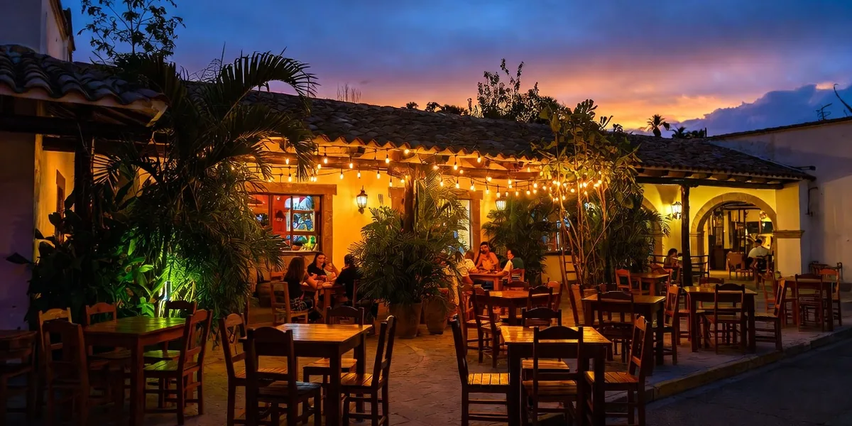 Grilled octopus tacos and mezcal cocktails on a candlelit restaurant table in Tulum pueblo