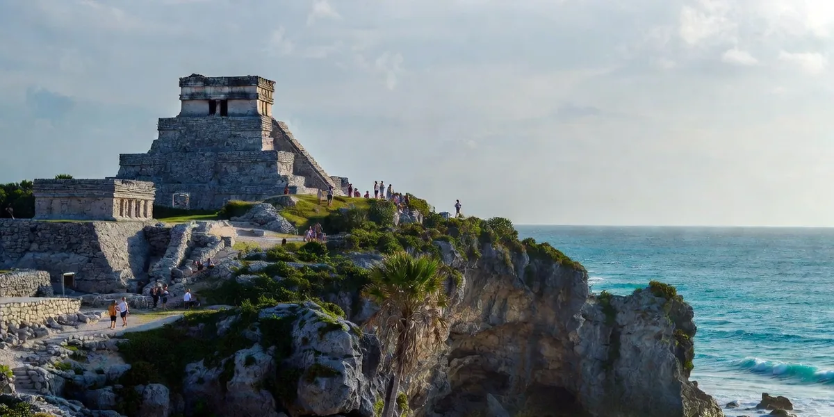 Tulum Mayan ruins on the cliff above turquoise Caribbean water and a small beach cove